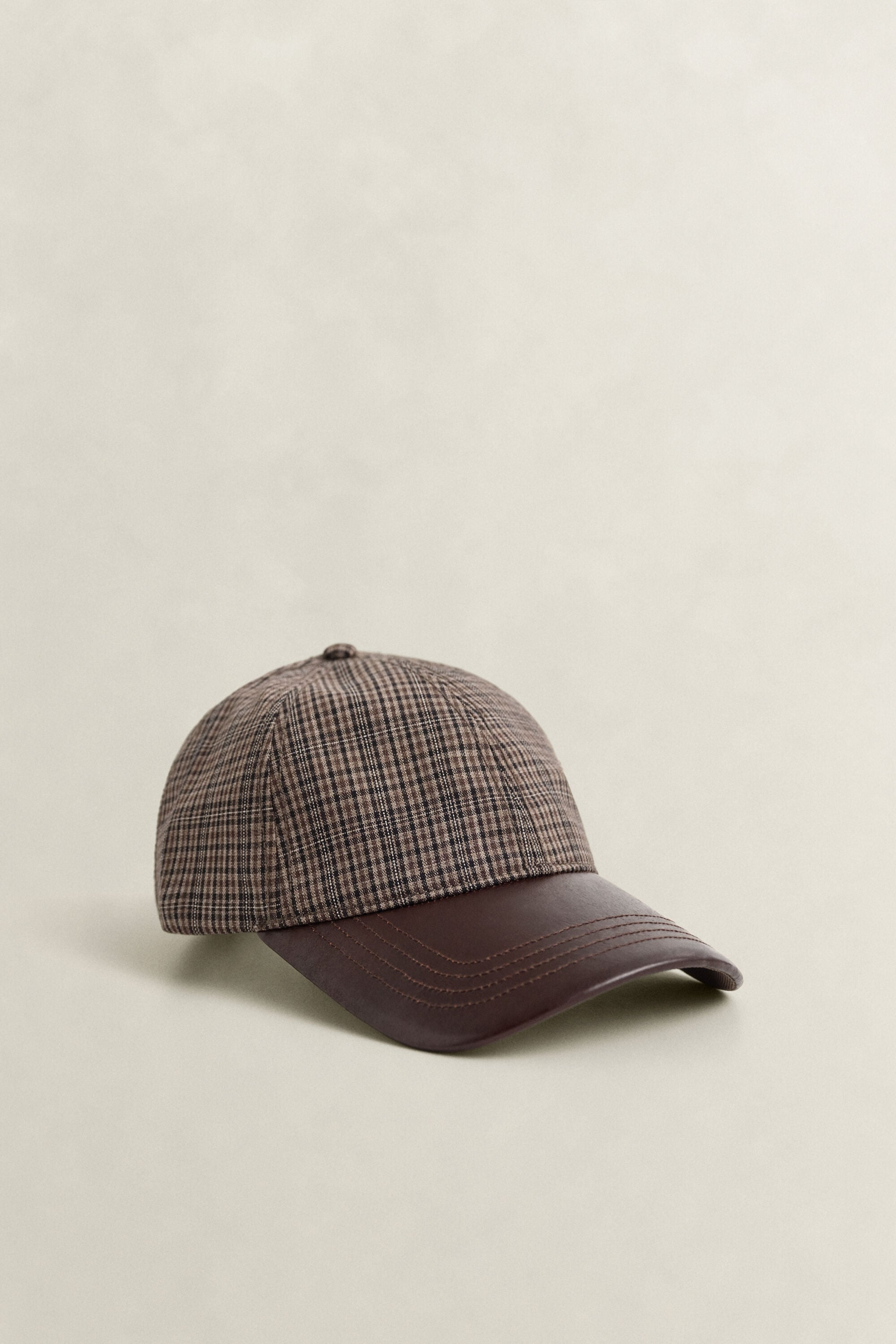 Casquette en laine à carreaux avec visière en cuir